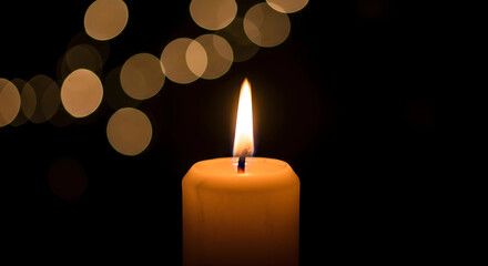 burning candle on a dark background