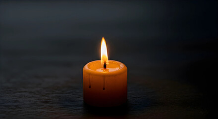 burning candle on a dark background