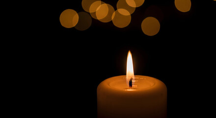 burning candle on a dark background