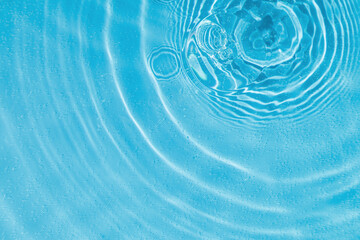 drops on water with circles on a blue background