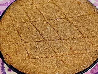 Plain basbosa or basbusa with honey sugary syrup on it, Basbusa is a middle eastern dessert that is...