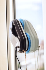 Robot washer washes window, window cleaning process with modern household appliances
