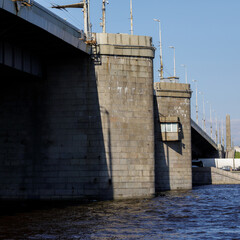 View of the Volodarsky Bridge in Saint Petersburg, showing its heavy stone supports, observation...