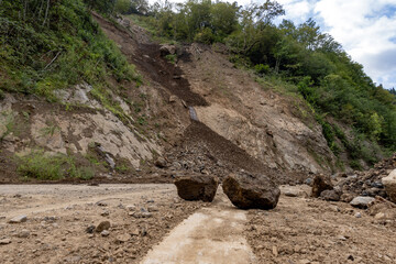 Landslide Rocks Blocking Road with Visible Lane Markings | High Resolution Photo