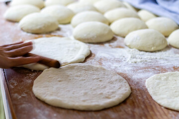 Homemade dough on wooden table at home.