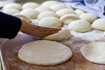 Homemade dough on wooden table at home.
