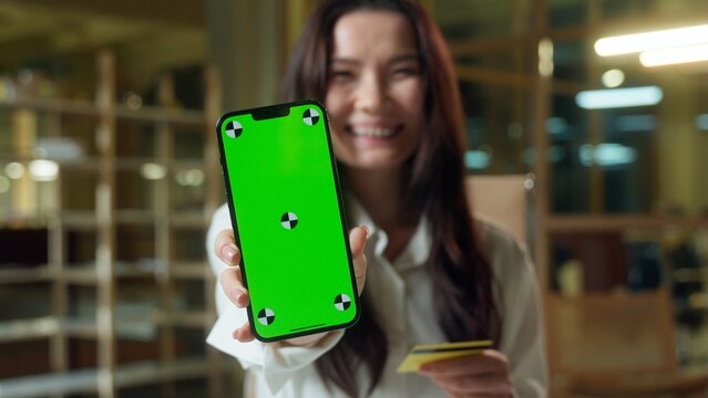 Asian business woman Chinese businesswoman pay money credit card banking mobile phone green screen in office Korean Japanese girl happy buyer shopping online crypto payment internet bank chroma key