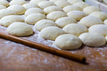 Homemade dough on wooden table at home.