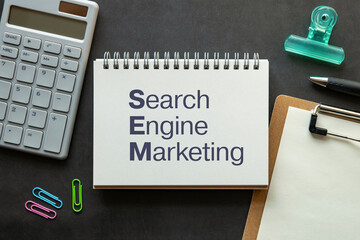 There is notebook with the word Search Engine Marketing. It is as an eye-catching image.