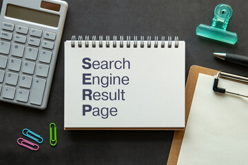 There is notebook with the word Search Engine Result Page. It is as an eye-catching image.