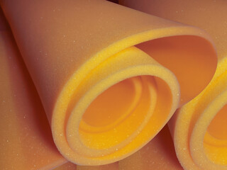 dark yellow foam sponge circle. yellow sponge foam material rolled into a spiral shape
