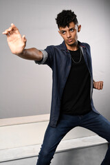 model young slim man in denim shirt in kung fu pose frontal