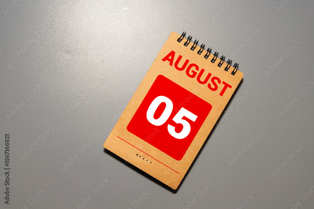 Poster wooden block calendar with the date august 05 and spikelets of wheat.