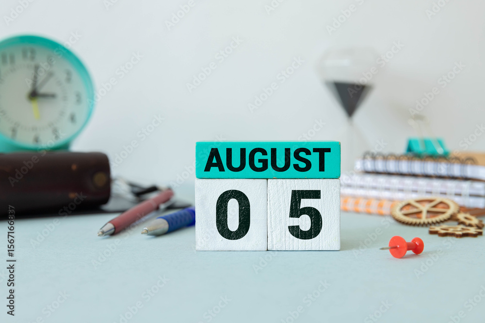 Poster wooden block calendar with the date august 05 and spikelets of wheat.