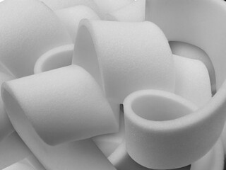 a collection of thin white sponge foam in circles. circular pieces. elastic, supple and soft...