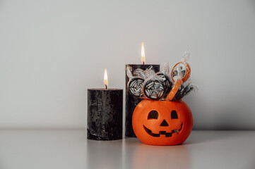  halloween candies and treats in pumpkin bucket , trick or treat concept. copy space banner