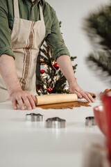 Vertical banner of man rolling out the dough preparing cookies for chrismas