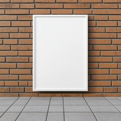 A blank white poster frame mounted on a red brick wall above a tiled gray floor.