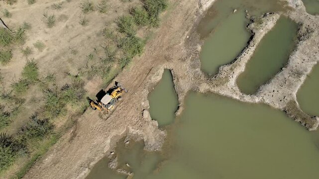 Drone Footage of Heavy Machinery Leveling Ground in Agricultural Land
