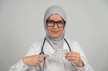 Female doctor in hijab recommends medications. 