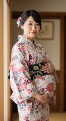 A pregnant woman in a kimono holds her belly