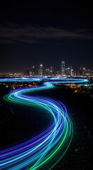 Colorful light streaks illuminate the night sky over the cityscape