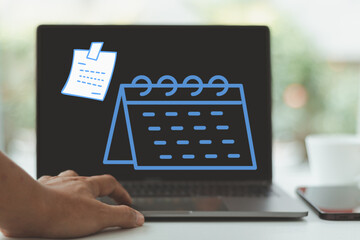 A man's hand is using a laptop displaying a digital calendar and note icon, representing work schedule, event planning, and time management for business and personal productivity in a modern workspace