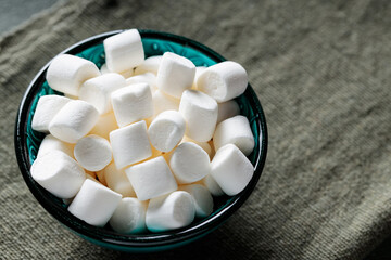 Tasty Marshmallow Snack in Turquoise Bowl with Green Background