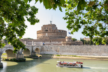 Castle Sant Angelo and a cruise boat on the river Tiber in Rome, Italy