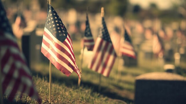 American flags wave proudly in a cemetery, honoring the fallen