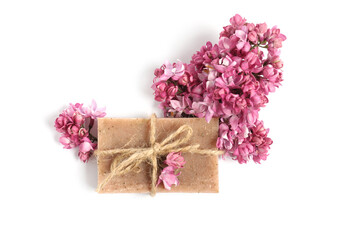 Soap bar and lilac flowers isolated white, top view