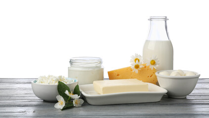 Different fresh dairy products and flowers on grey wooden table against white background