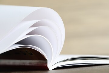 One open magazine on table, closeup view