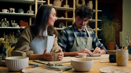 Happy woman man in pottery workshop creating handmade clay modeling class teacher student craft hobby sculpture couple date family potter artisan handcrafting ceramics have fun laughing in art studio