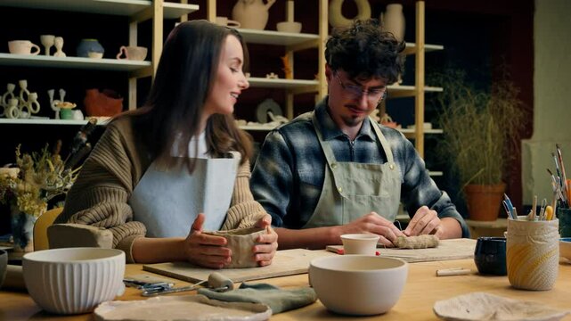 Happy woman man in pottery workshop creating handmade clay modeling class teacher student craft hobby sculpture couple date family potter artisan handcrafting ceramics have fun laughing in art studio
