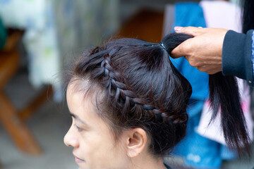 Beautiful Thai girl enhances her beauty with braided hair.