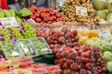 A vibrant fruit market display with a variety of tropical and im