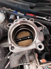Car engine repair showing throttle body cleaning, sensor inspection, and spark plug maintenance during regular vehicle servicing