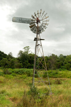 Portrait scene of an eco-friendly windmill water pump on  farm land in rural  Australia.