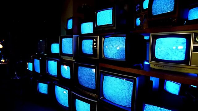 Vintage televisions displaying static noise in dark room for retro aesthetic and technology concepts