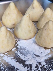 Brazilian Coxinha Dough Shapes on Floured Tray. Traditional Homemade Snack Preparation