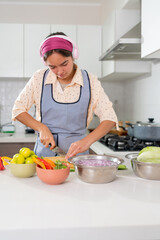 Young chef preparing ceviche, slicing ingredients in kitchen