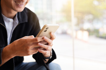 close up businessman hand  hold smartphone to surfing the internet and check work or mail on website while sit in the living room in weekend for business technology and lifestyle concept