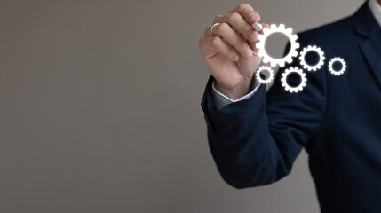 close up young businessman manager hand use stylus pen and draw gear setting for build or create about business process and solution concept with copy space background