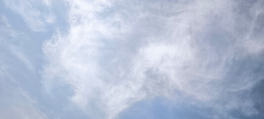 sky is blue and clear with clouds. The sun is shining brightly