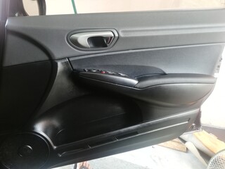 Car soundproofing installation using butyl sheets, foam, and acoustic dampening materials in...