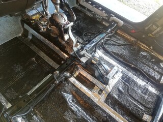 Car soundproofing installation using butyl sheets, foam, and acoustic dampening materials in...