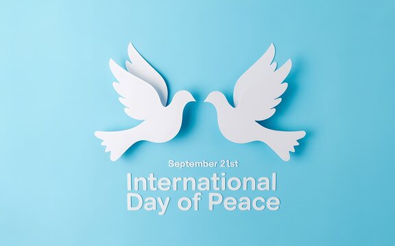 Two white paper doves facing each other on a blue background celebrating international day of peace