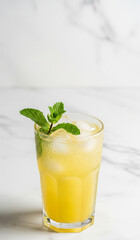 Chilled lemon tea with mint served on a white table, healthy and refreshing