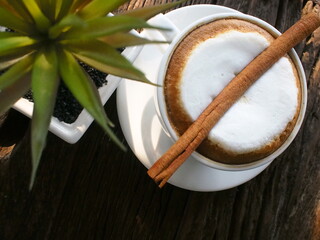 Hot coffee with cream and cinnamon